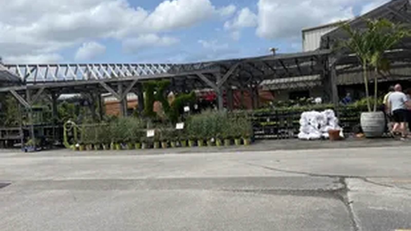 The covered entrance and plant-filled outdoor area at Waldo Greenhouse in Kansas City.
